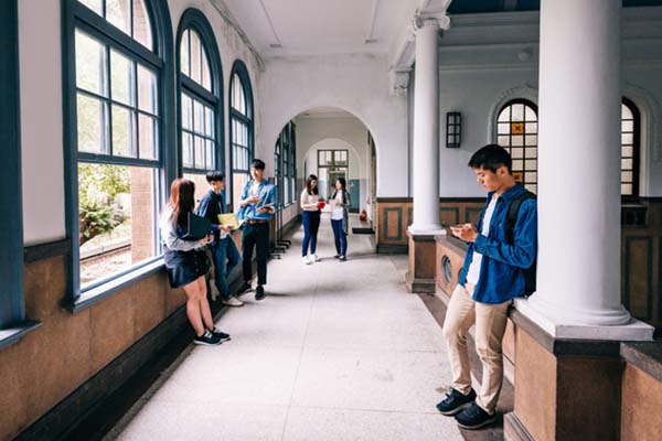 College hallway filled with students lounging and chatting