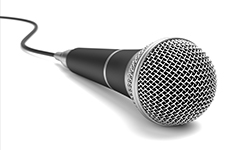 Corded microphone laying on white background 